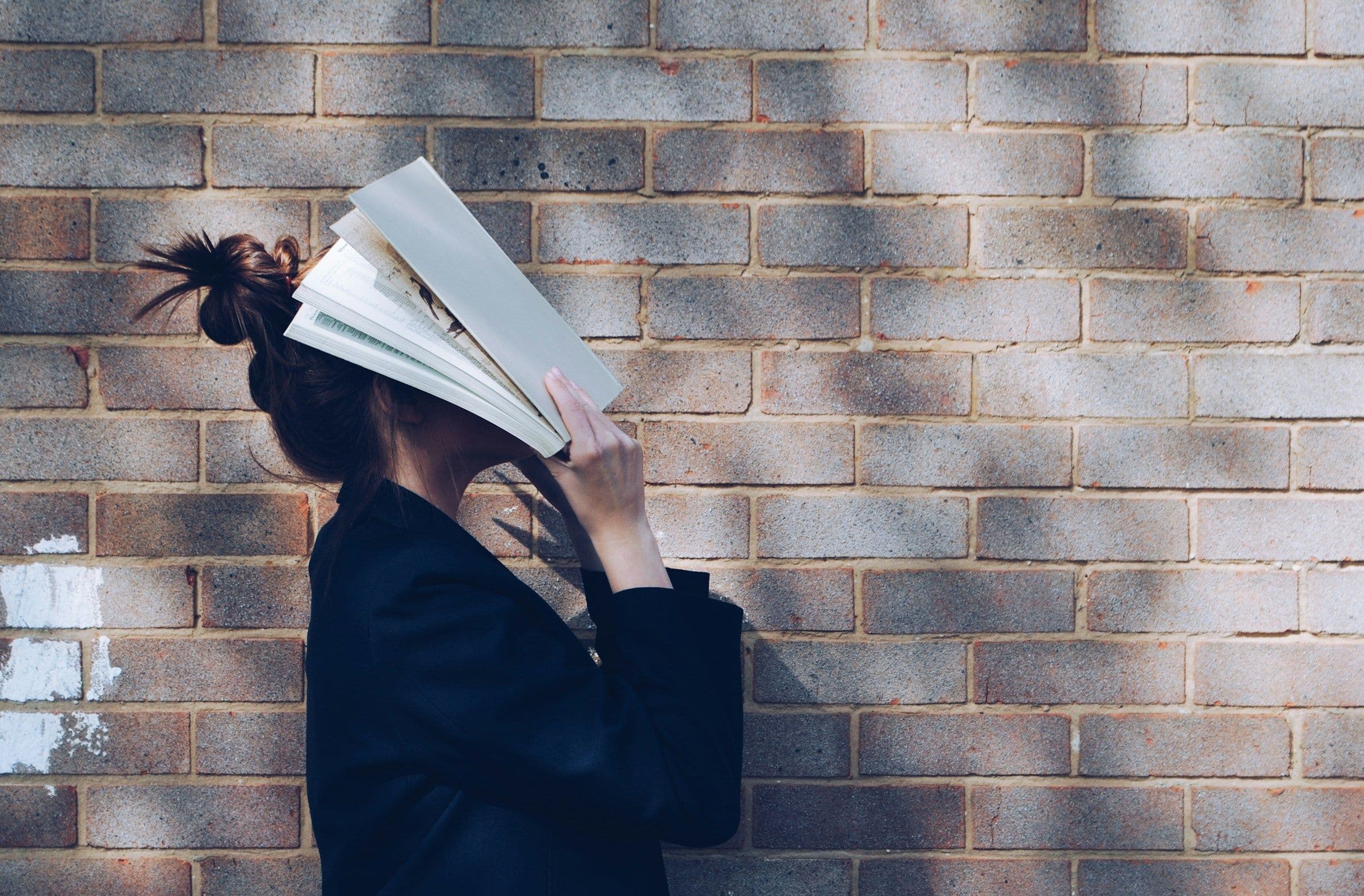 Girl Holding Book - How to Study Geography