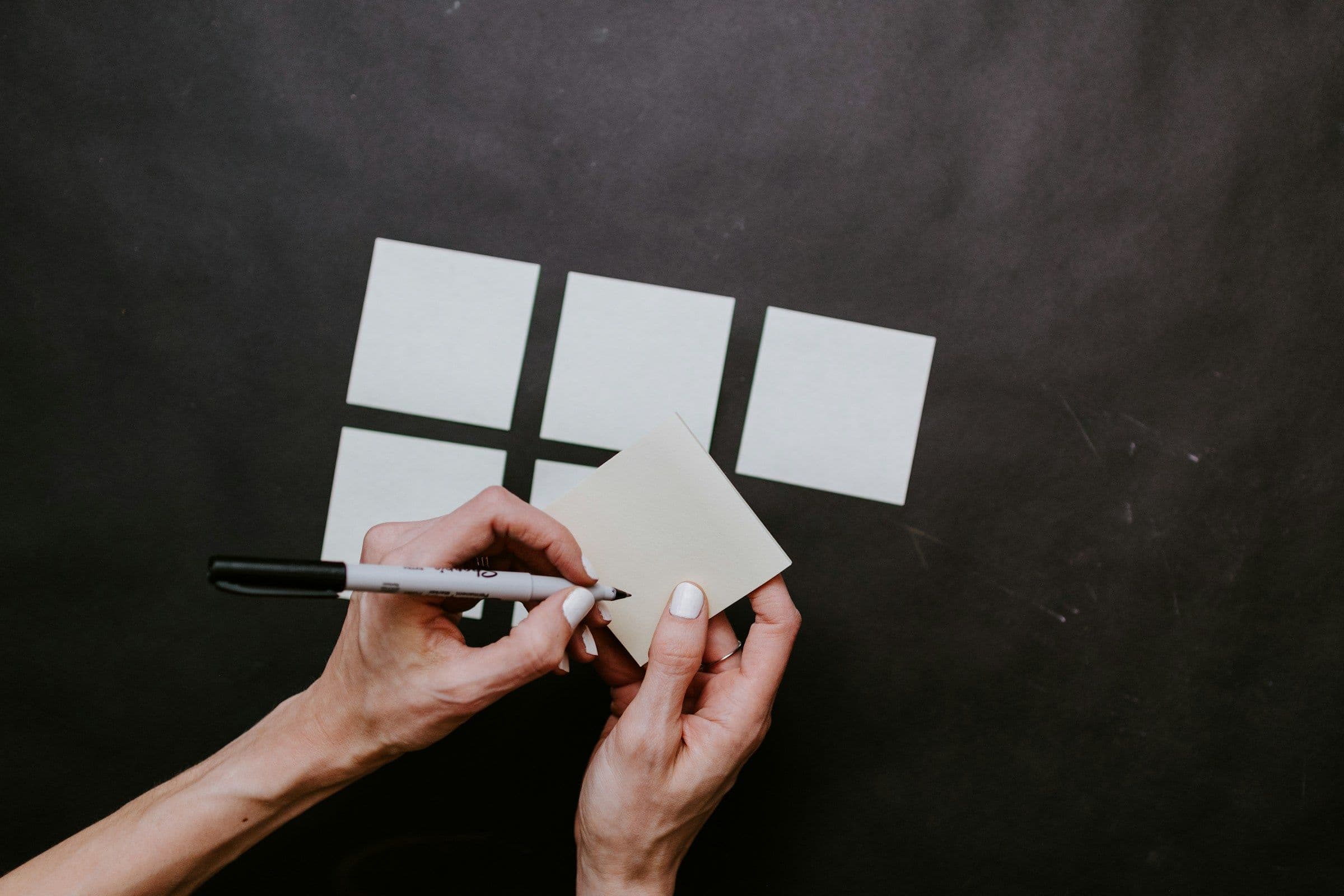 person writing on flashcards - How to Memorize Flashcards