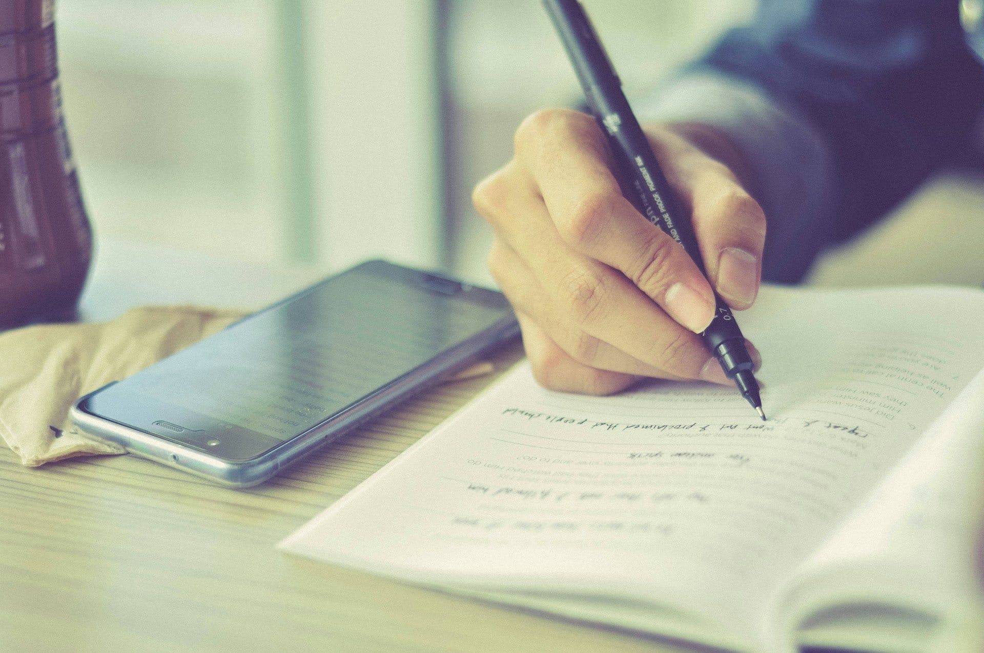 person taking notes - Why Is It Important to Take Notes During Lectures or Discussions?