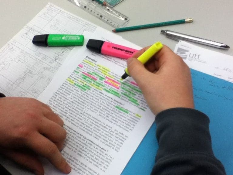person highlighting notes - Passive Vs Active Studying
