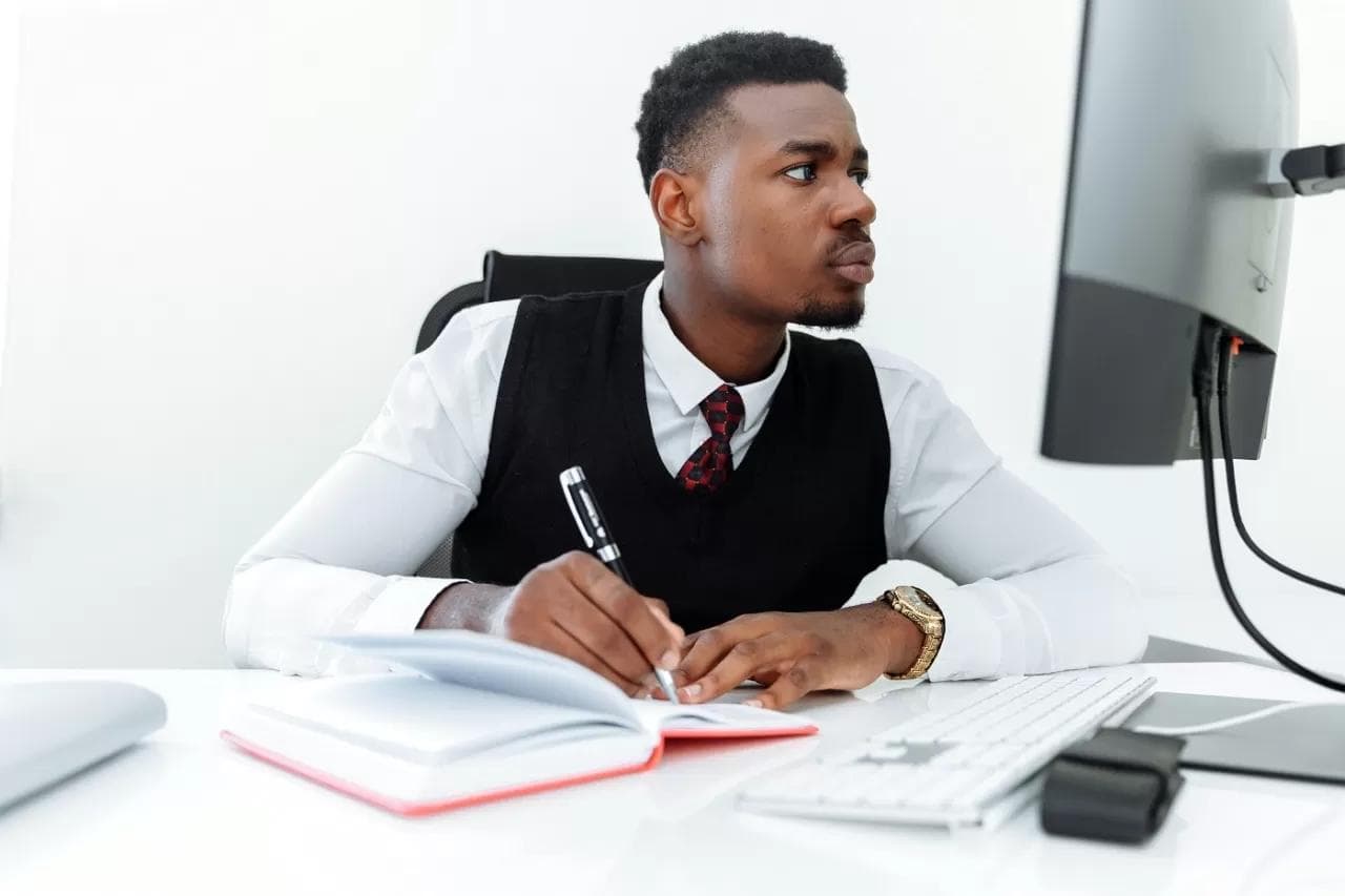 person making and writing notes - How to Study for Accounting